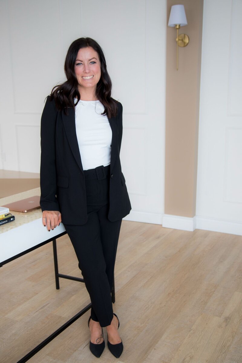 Erin standing at desk smiling at camera