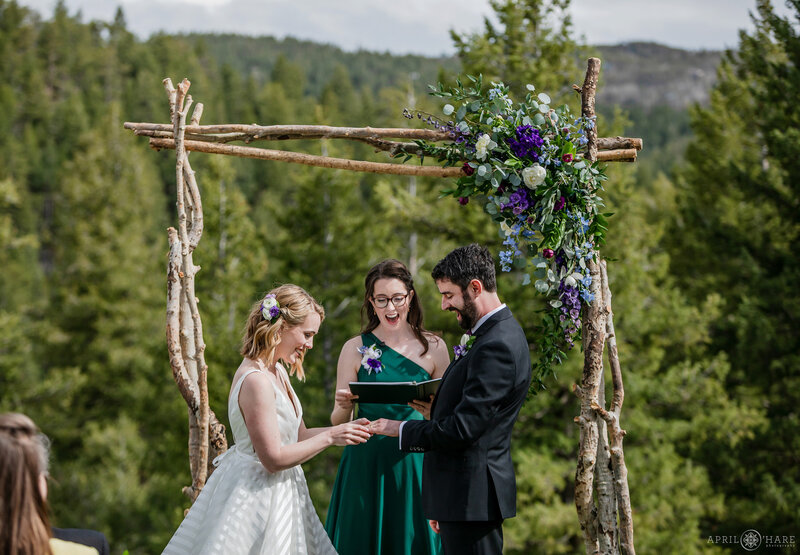 Wedding Ring Exchange at Outdoor Wedding Ceremony at The Woodlands Barn wedding venue in Colorado Mountains