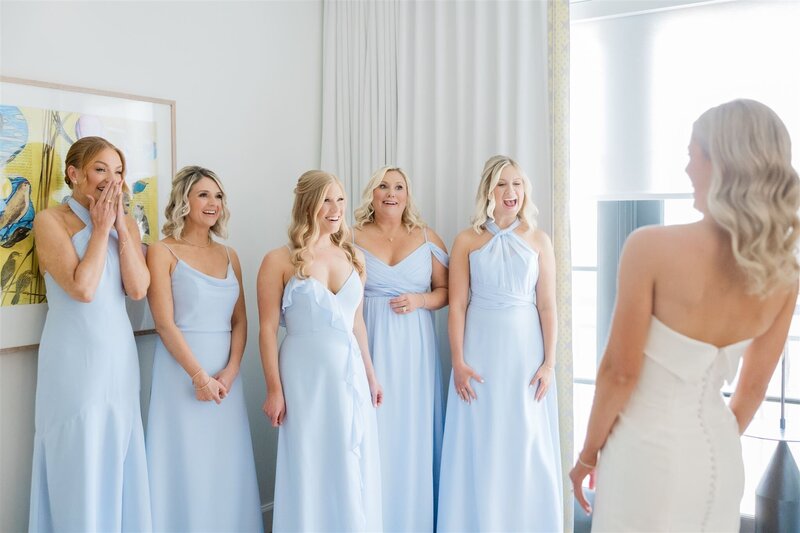 A first look with bridesmaids in light blue dresses at the Alfond Inn, Winter park.