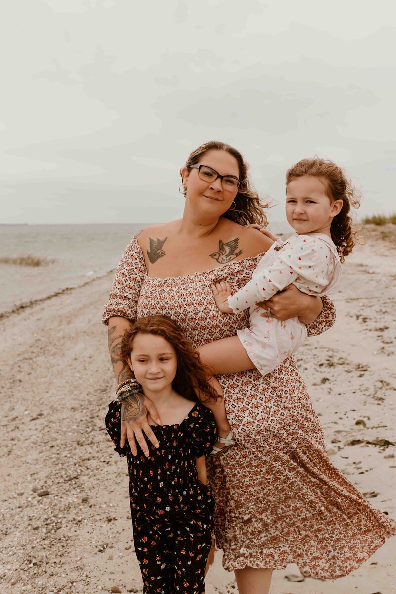 Portrait of mom and daughters at the beach.