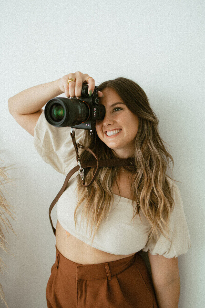 south florida wedding photographer emma holding camera