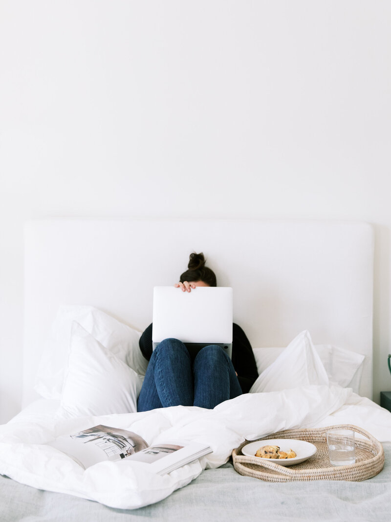 woman on laptop in bed