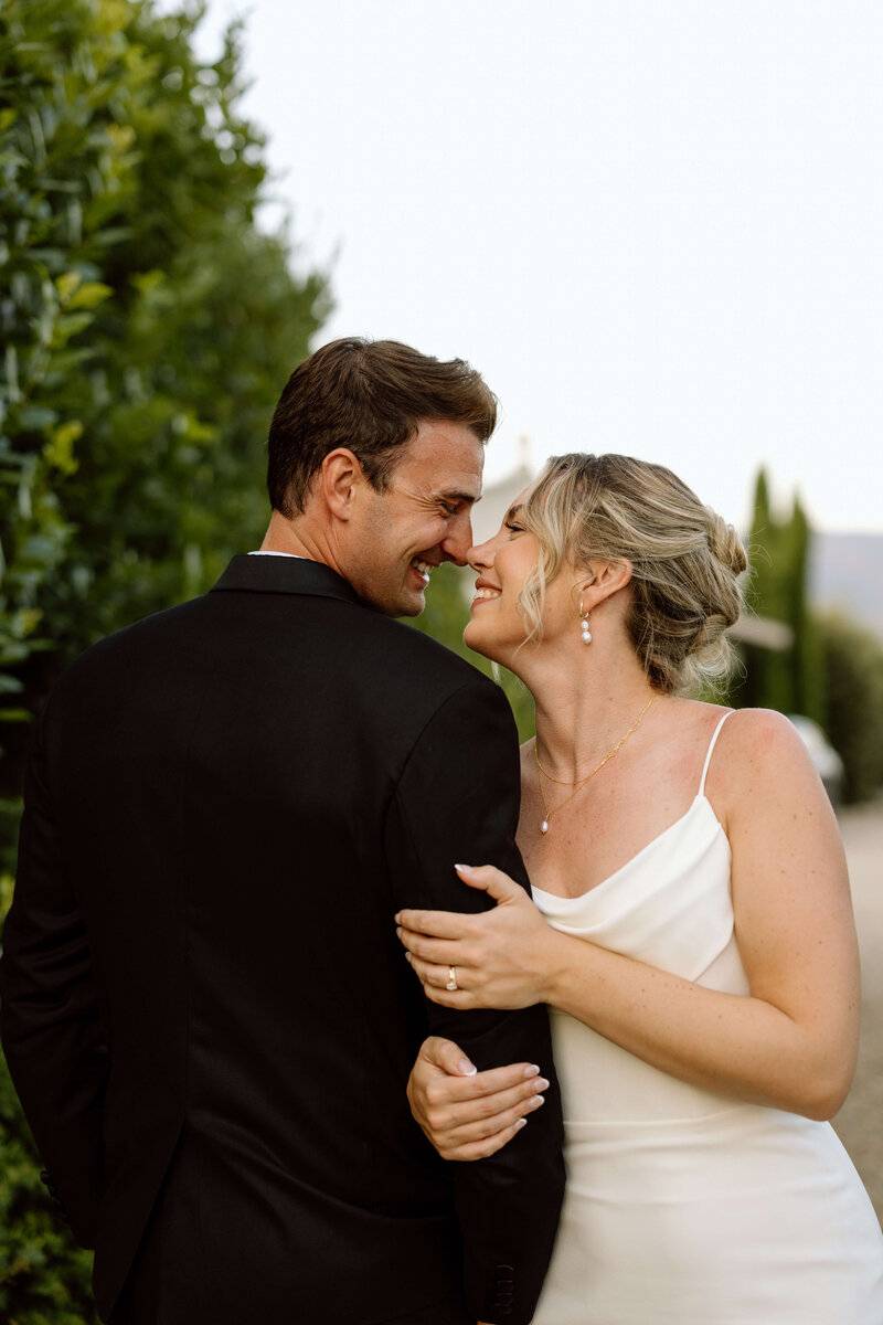 A Canadian bride and groom embracing during their wedding in Tuscany, Italy