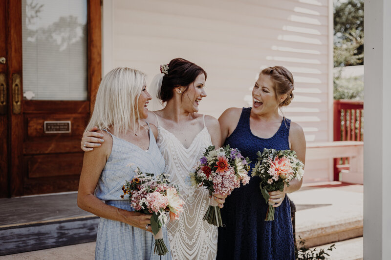 bride and bridesmaids lauhging