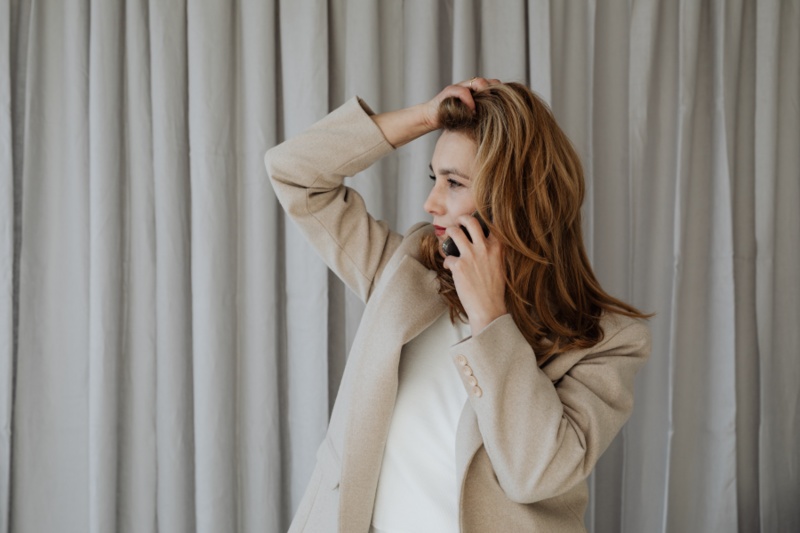 Young creative woman in cream linen suit posing next to camera stand | Brand By Design