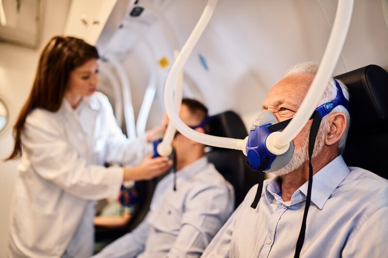 senior-man-breathing-through-mask-oxygen-therapy-hyperbaric-chamber