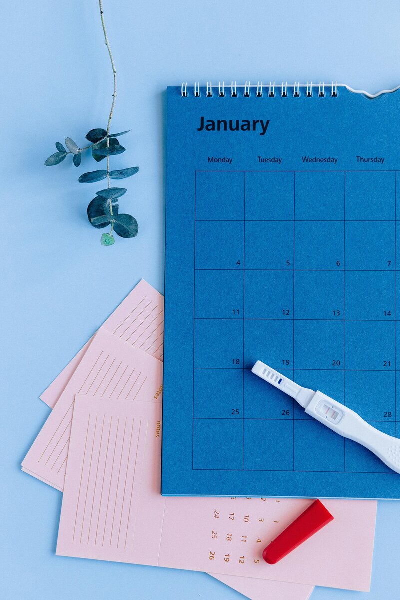 A Blue Sky Fertility patient is tracking their periods on a blue calendar
