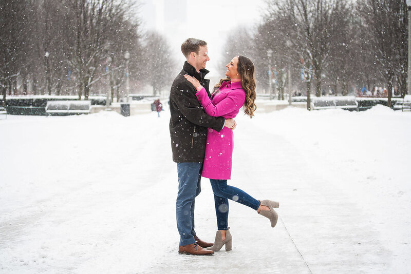 couple kiss during downtown detroit snowy winter engagement session