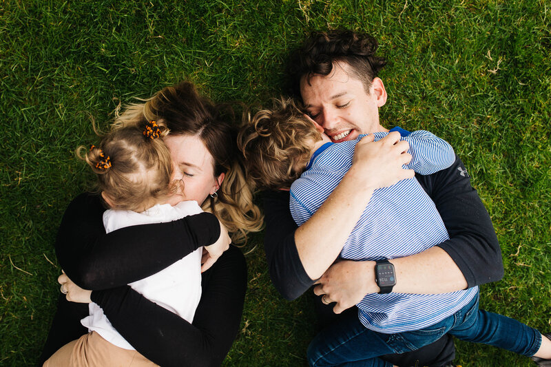 A mum and dad hugging their children on a family shoot