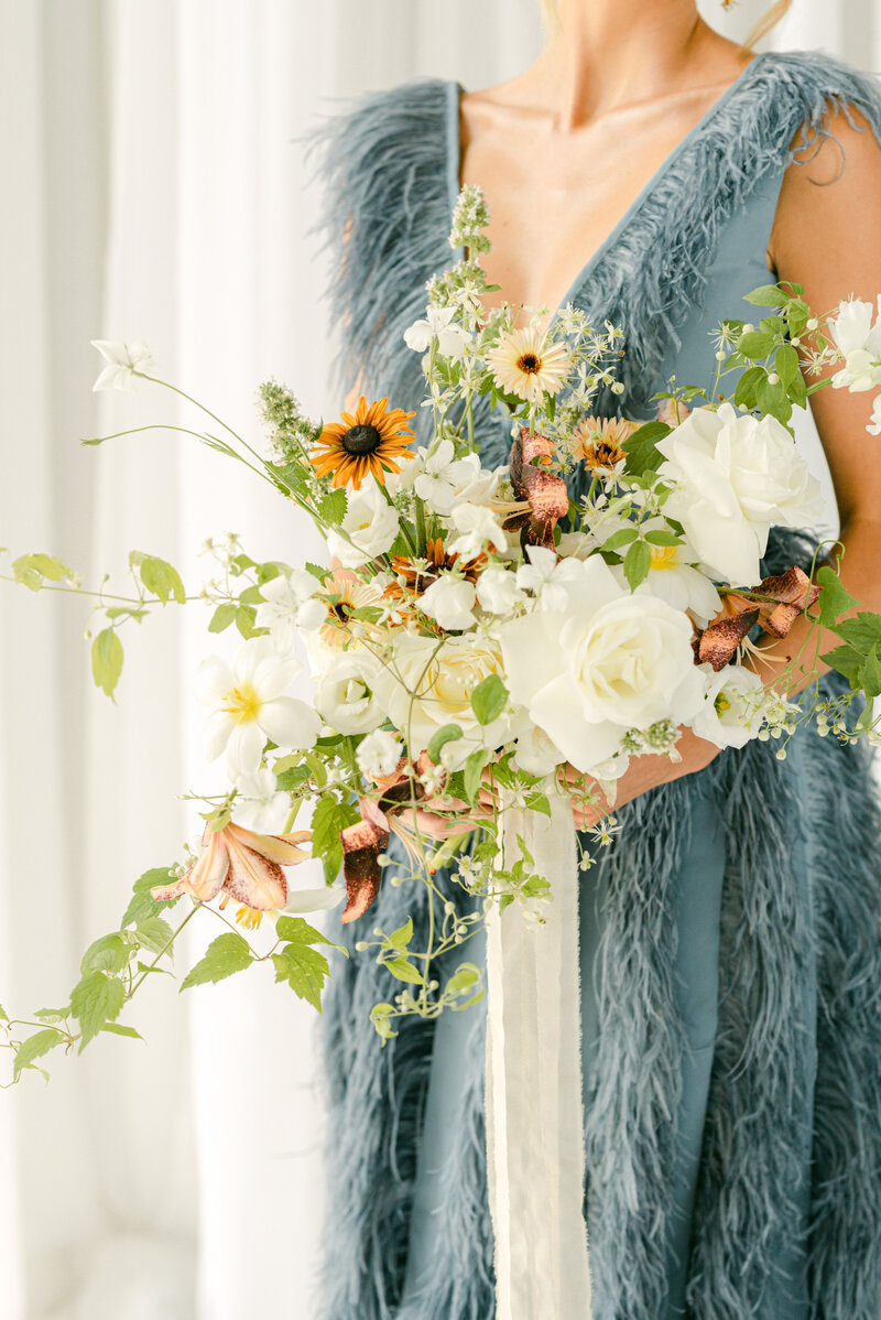 Bride With Ostrich Feather Blue Dress With White and Green Bouquet