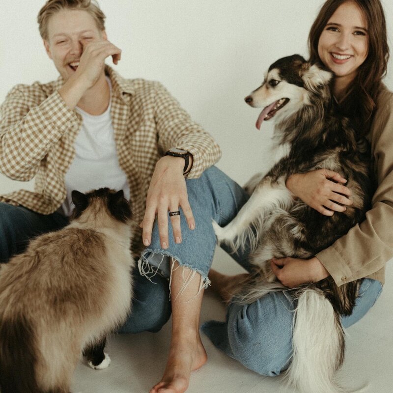 Hannah with her husband, dog, and cat, capturing a cozy and loving family moment at home.