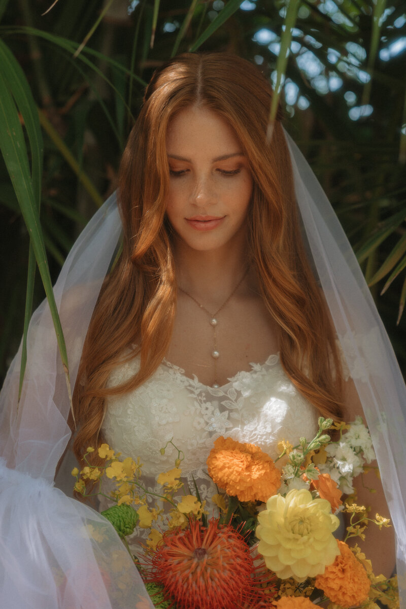 A woman in a white dress holds a mirror in her hands