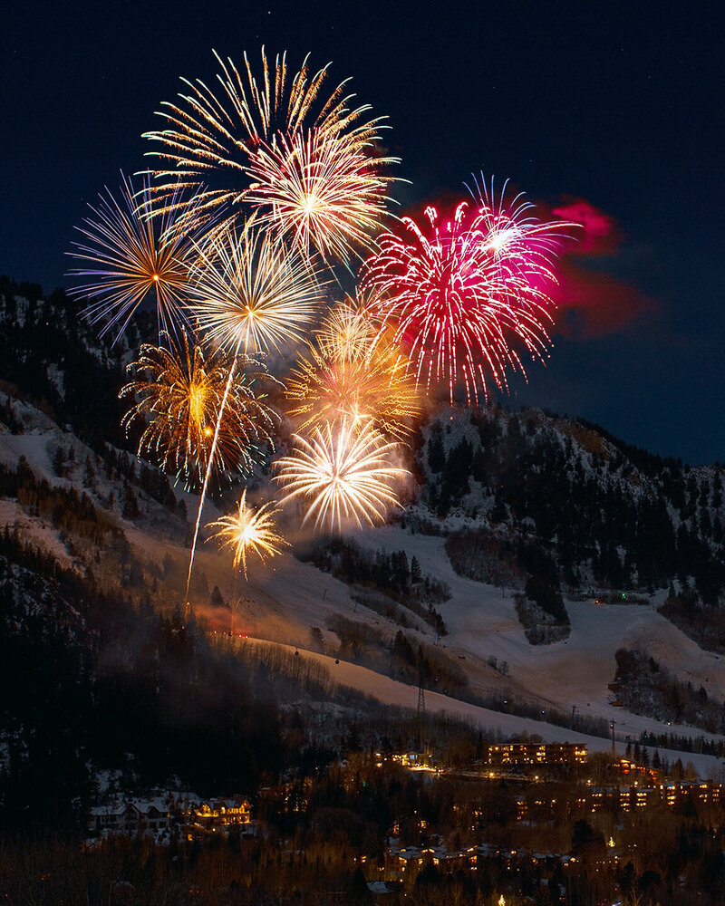 A fireworks display over a ski resort in France at a luxury party celebration.