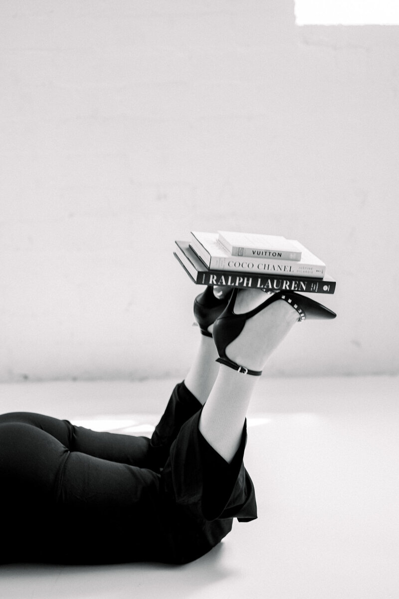 Books set on heels photographed in black and white.