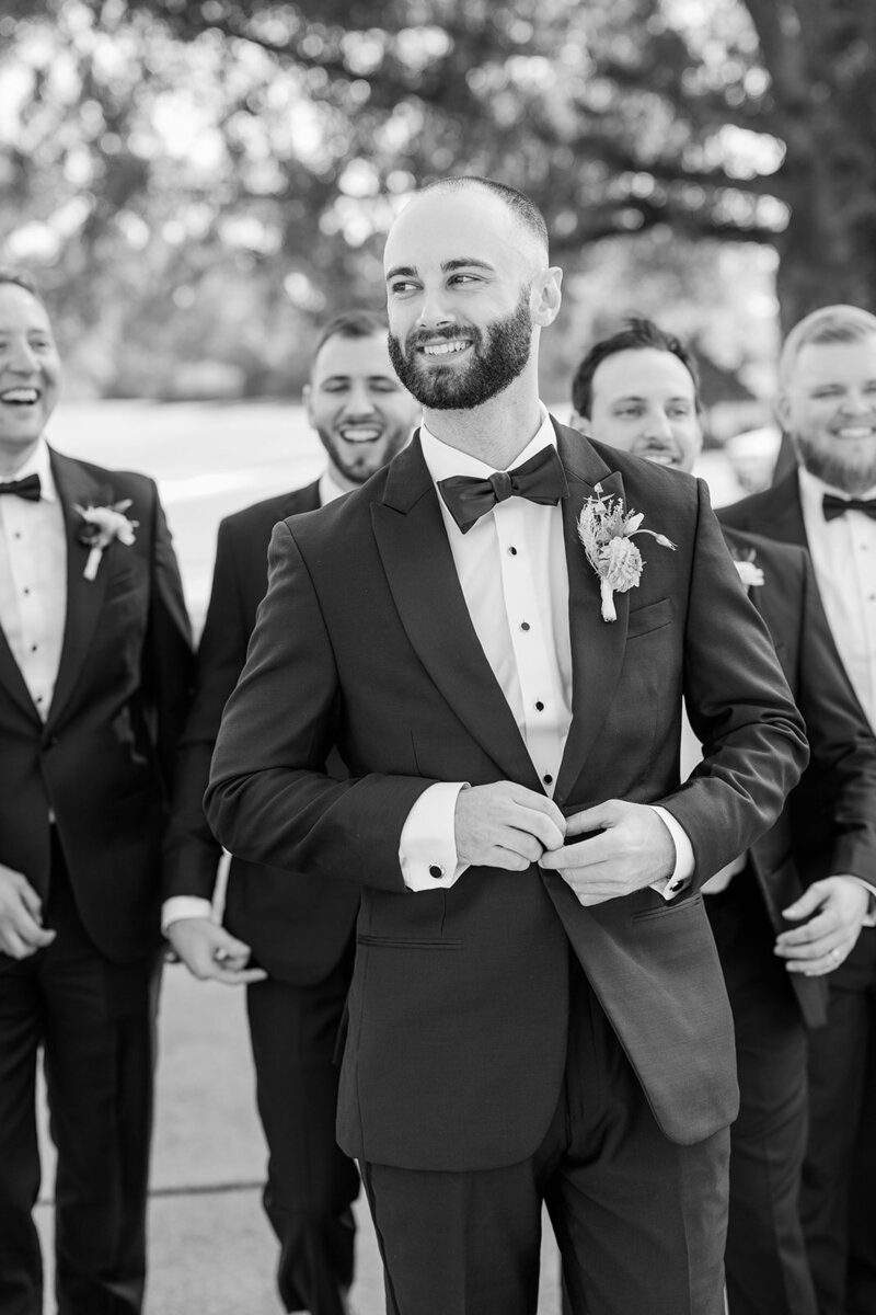 a man standing with his groomsmen on his wedding day