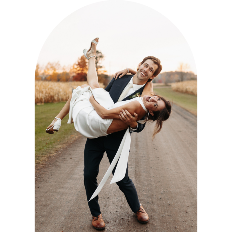groom carrying bride and both of them smiling