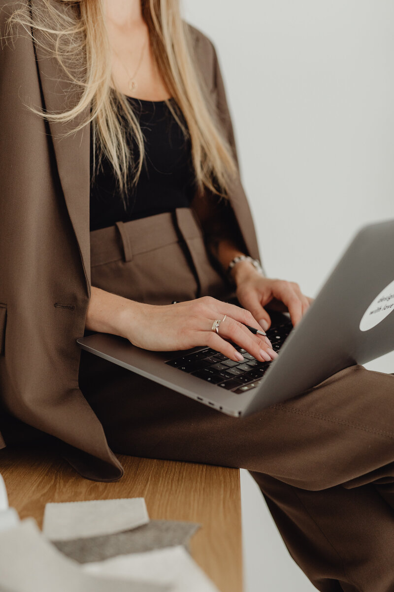 woman entrepreneur typing on laptop 