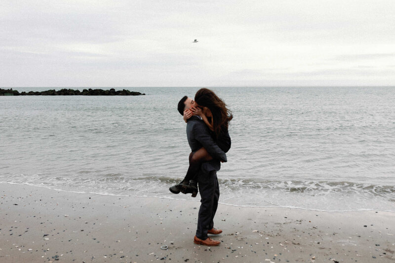 Brooklyn city hall elopement couple kissing on the beach at coney island