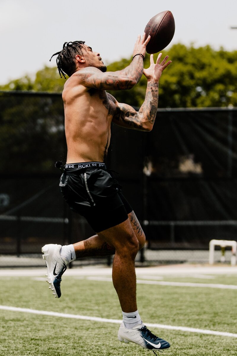 Athlete practicing football skills during The Athlete Project training session in South Florida.
