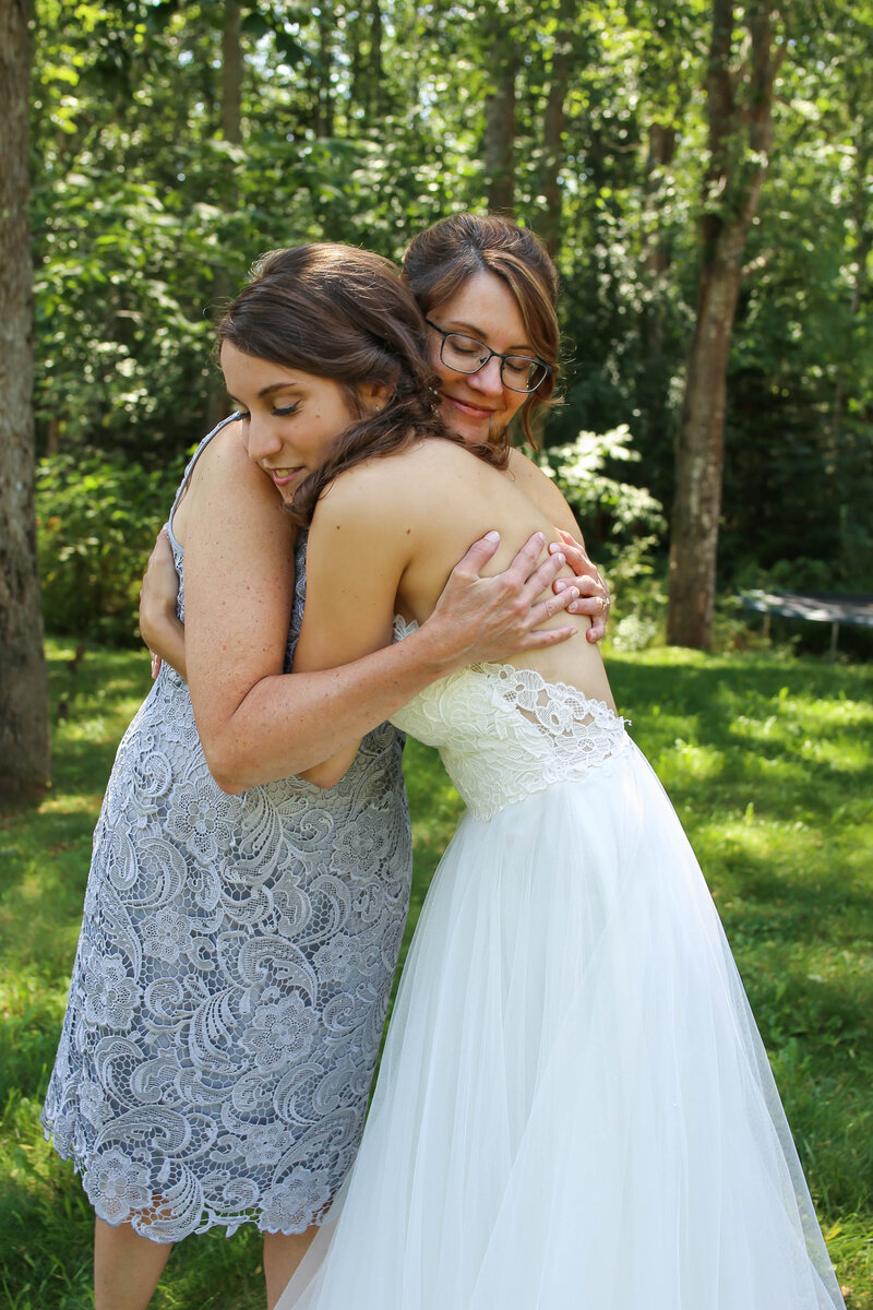 Bride hugging another girl | Wedding Photography in Acadia
