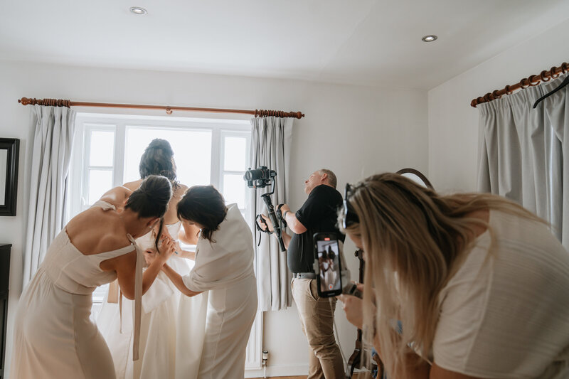The media team at a wedding working hard and collaborating