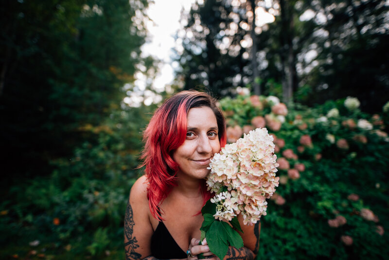 Arielle holding flowers and smiling at the camera