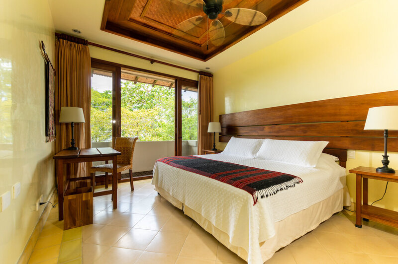 white bed with fan ocean view room blue spirit costa rica