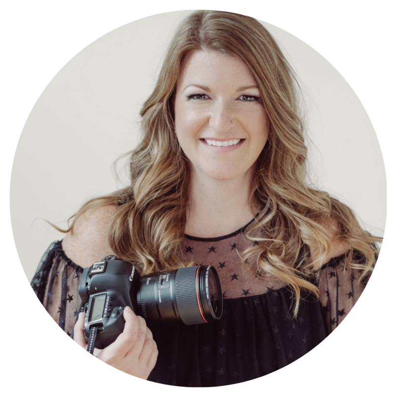 An image of the photographer smiling at the camera and holding her camera