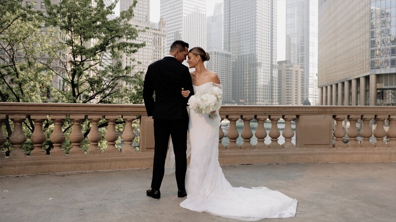 Bride and groom stand outside luxury venue in Chicago by the river