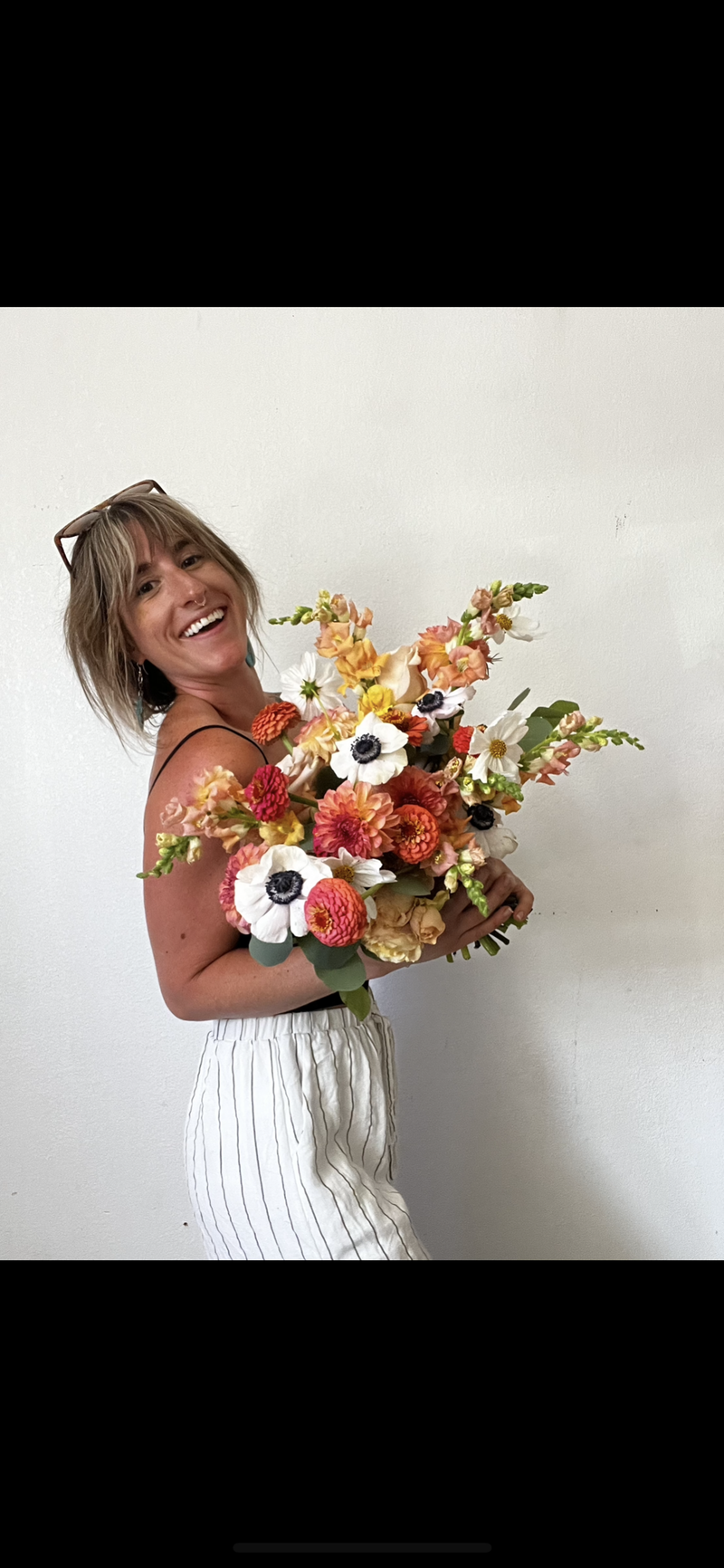 Portland Wedding Florist holding wedding bouquet, roses, snap dragons, anemones, zinnias, dahlias, cosmos