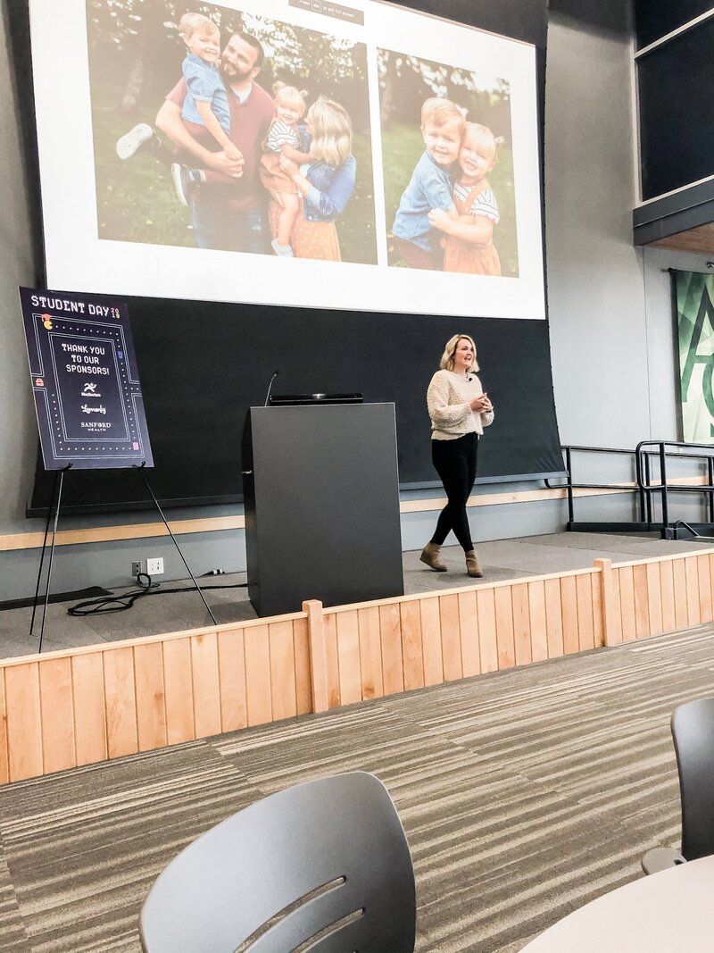 Maddie on stage giving a presentation at a Student Day event for SDAF