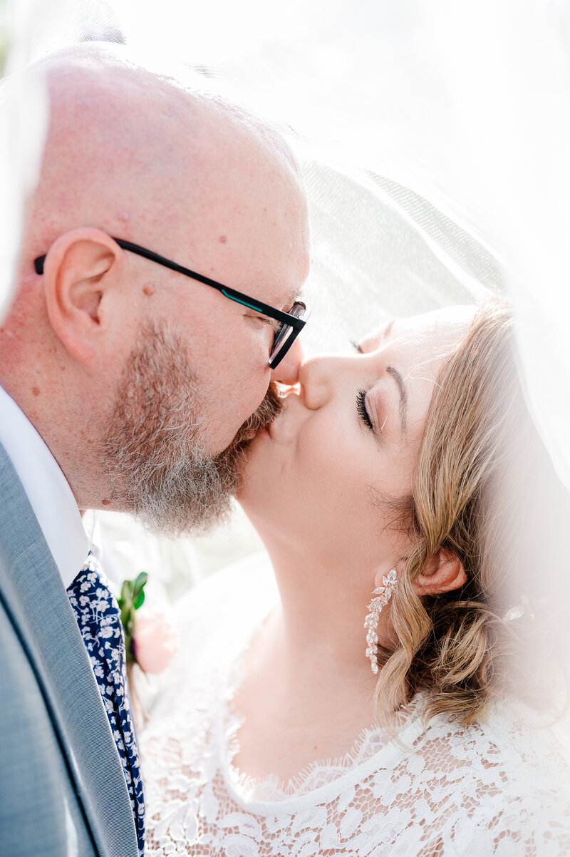 couple kissing during wedding day