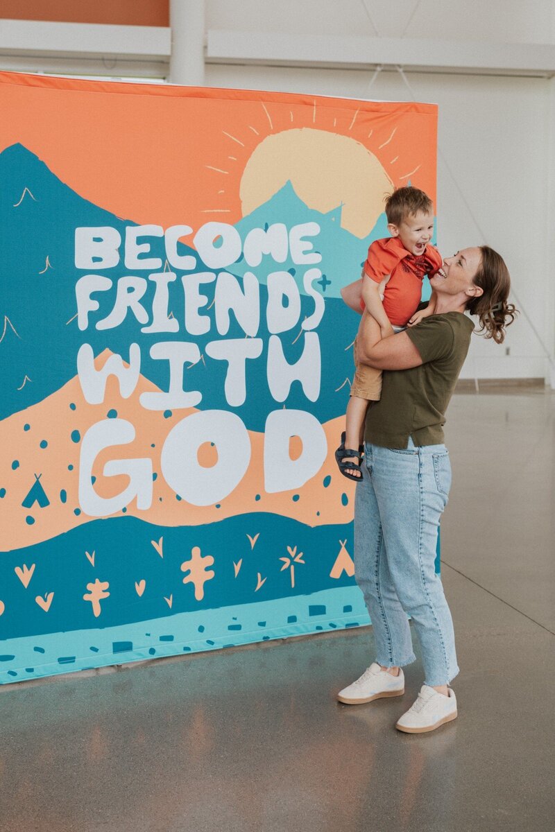 A woman holding her child laughing