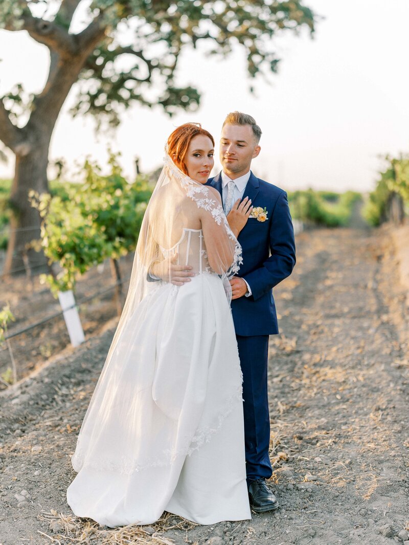  candid moment during a wedding reception in Paso Robles at allegretto resort as the Bride and Groom run into the reception and laugh and dance