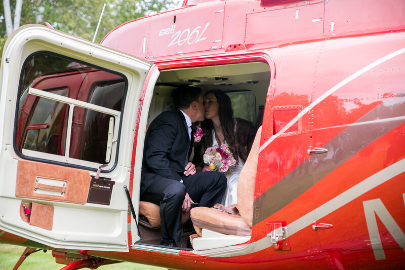 Bride and Groom kissing in helicopter | Wedding Photography taken by Maine Photographer