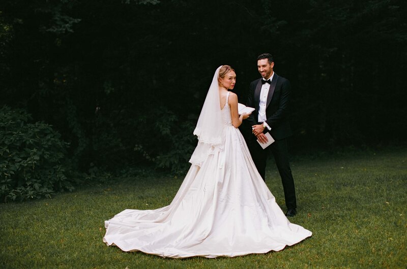 Two woman walking to their wedding reception among friends and family
