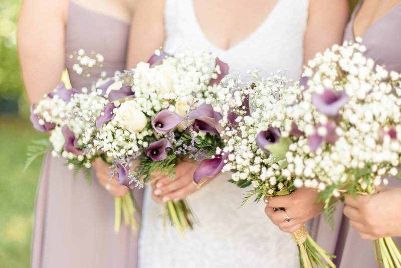 Up close picture of lavender, purple, and white wedding bouquets