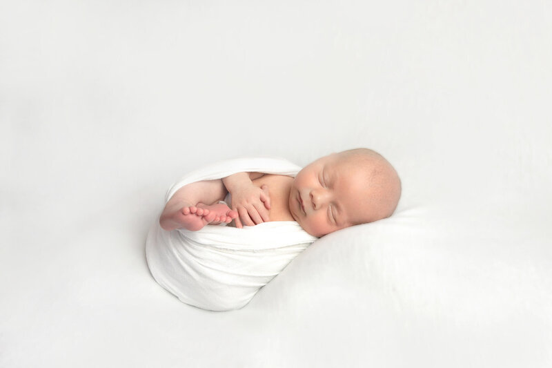 Blanket posed newborn on a white blanket during an in home Philadelphia Newborn Session
