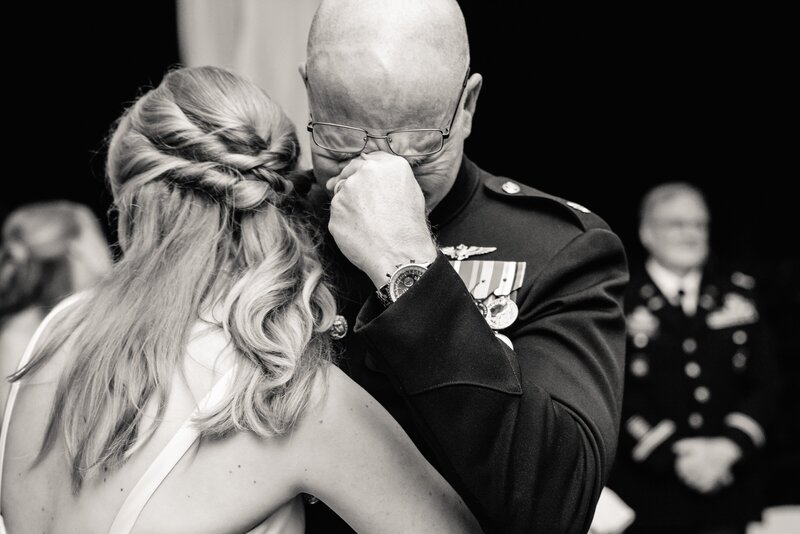 a military dad cries while dancing with his daughter at her wedding.