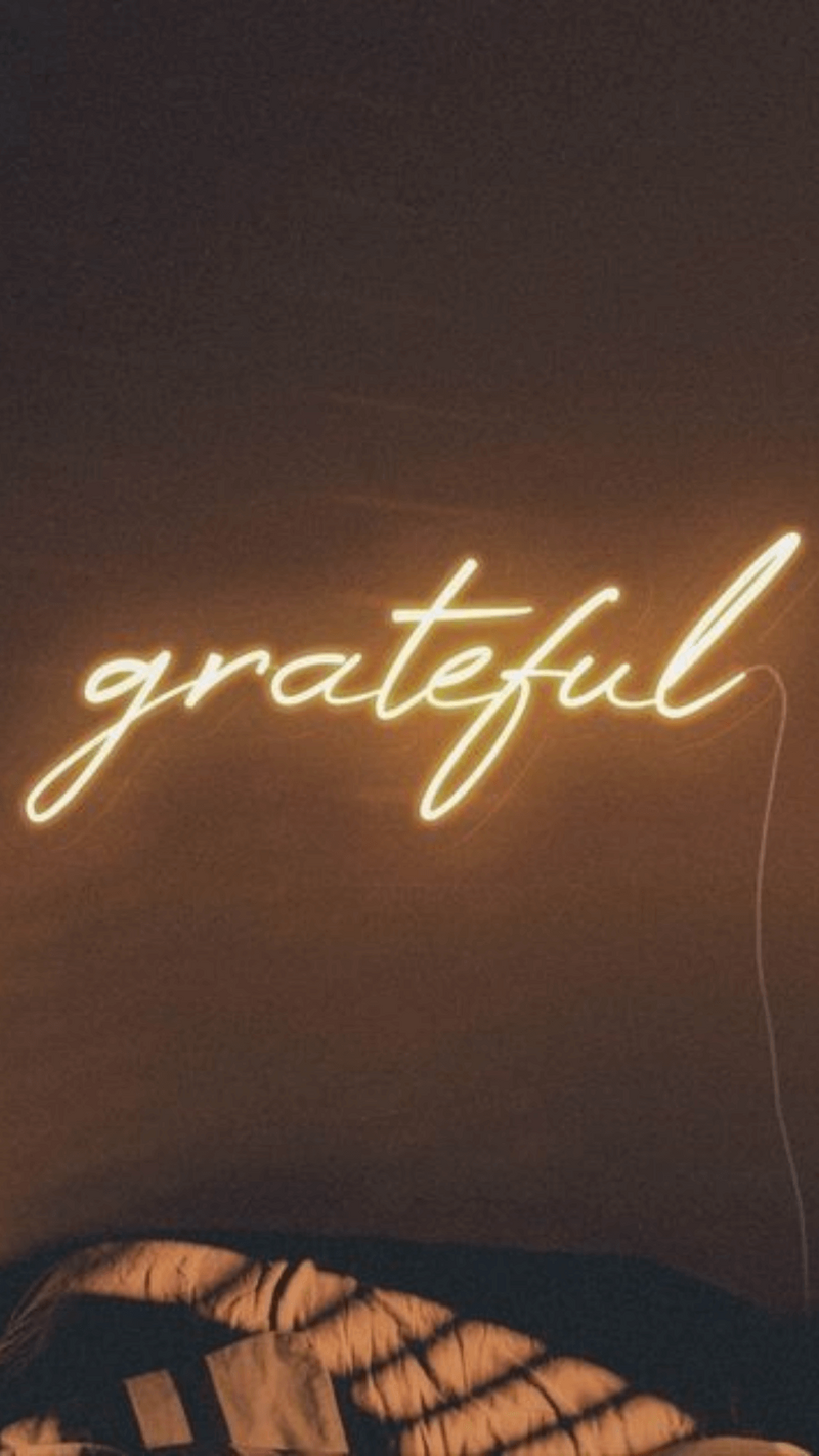 Pam sitting at her desk in front of a window writing out a podcast strategy plan