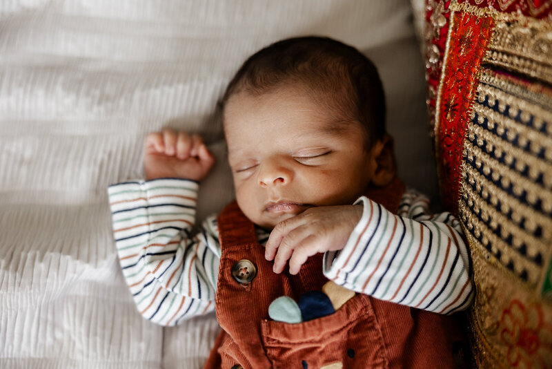 A close up of a newborn baby boy wearing overalls taken in St. Louis, Missouri. 
