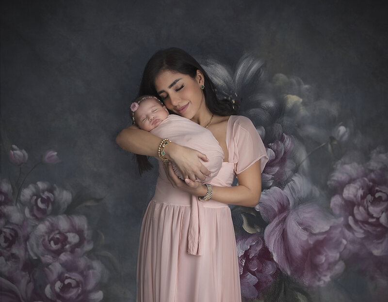 "Ottawa studio photo – mother in gown holding newborn tenderly"