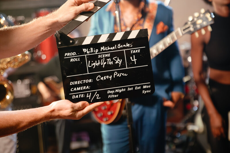 Go behind the scenes of a vibrant music shoot captured by Karen Pride in Nashville, Tennessee. This engaging photo features a director’s clapboard in the foreground with a lively band performing in the background, offering a glimpse into the dynamic process of music production. Ideal for bands, musicians, and music enthusiasts looking to capture the essence of their performances and the excitement of live production. Discover more about Karen’s ability to blend storytelling with music photography.