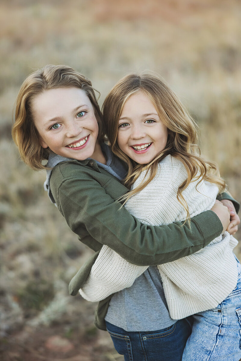 Siblings in Fort Collins hugging each other