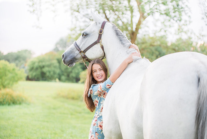 teen girl hugging her horse