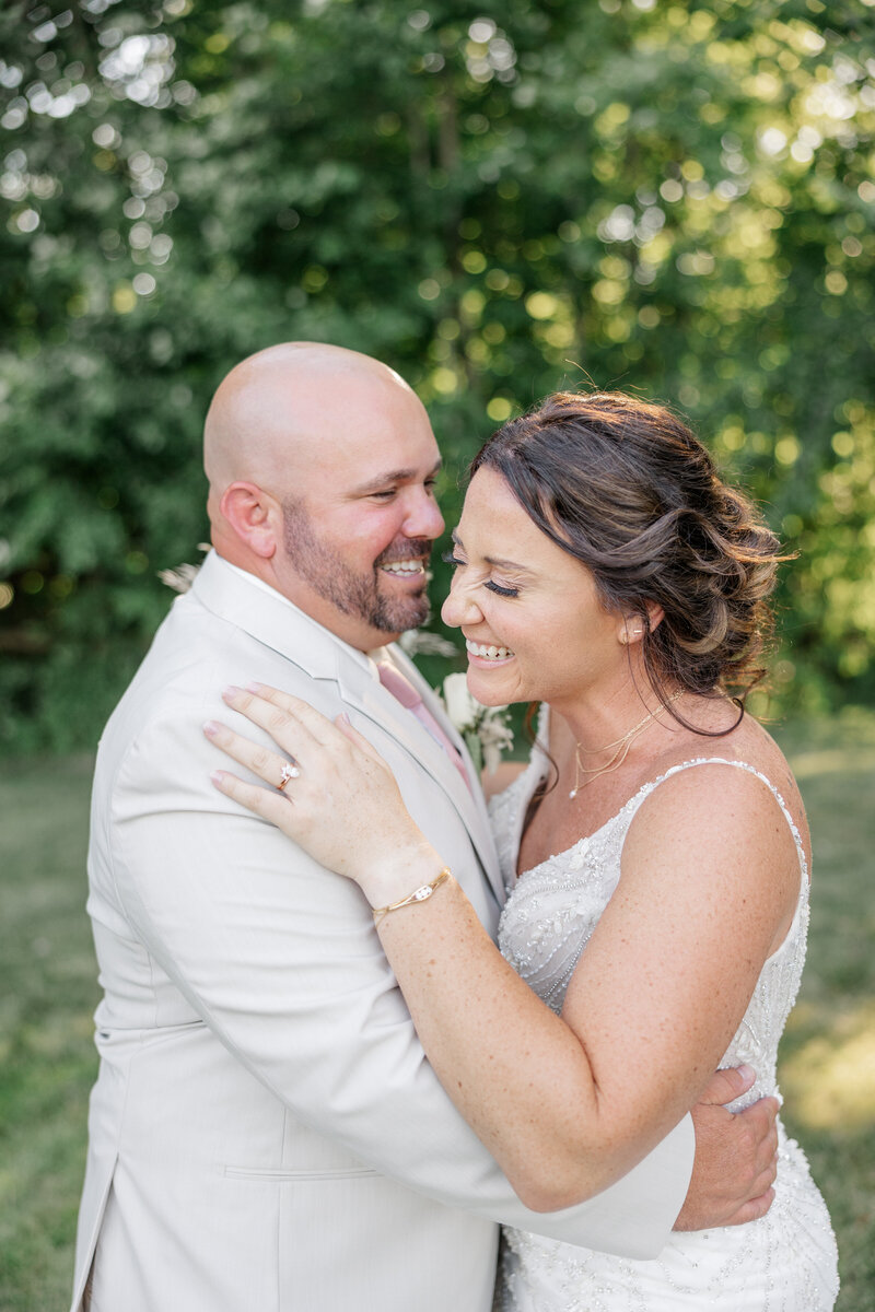 Bride & groom hugging and laughing together