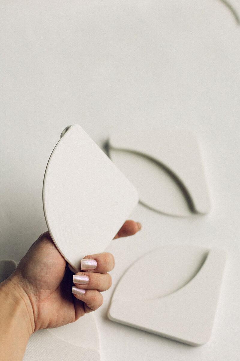 Mat Mates used to hold down styling mat corners for stable flat lay photography
