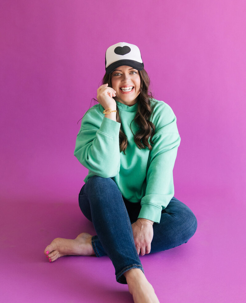 heather crabtree in teal sweatshirt with black and white hat