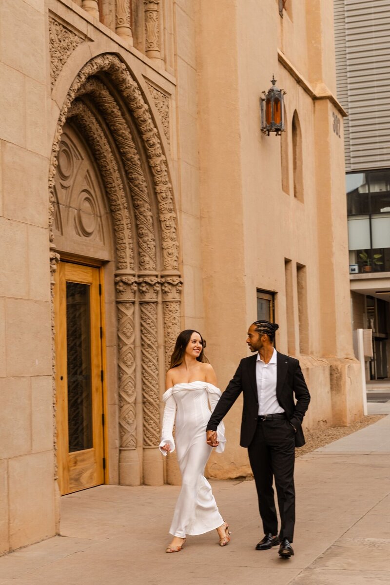 kenzie pellerins portfolio image of couple walking downtown holding hands