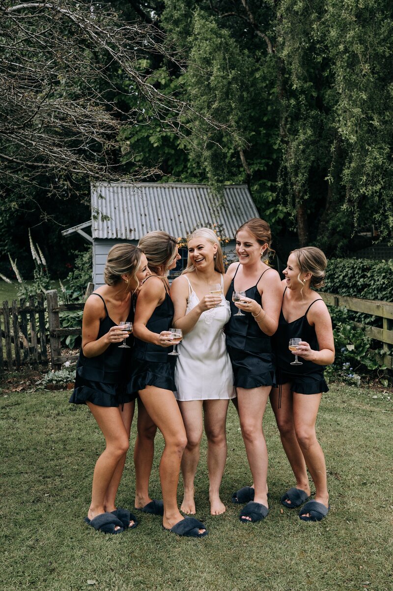 bridesmaids in black silk pajamas in waimumu southland on wedding day